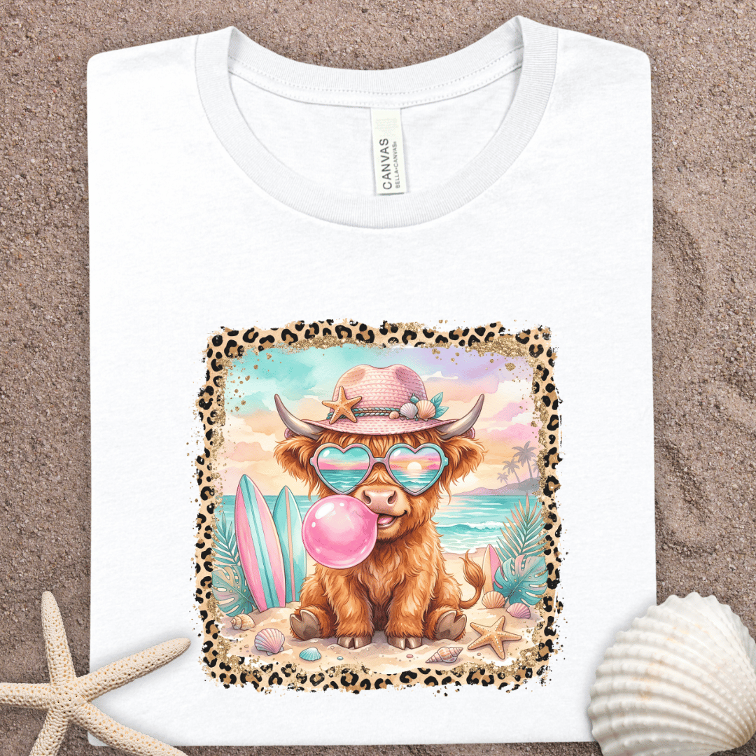 Highland Cow Beach T-Shirt - Surfing Cow with Sunglasses & Bubblegum Graphic Tee